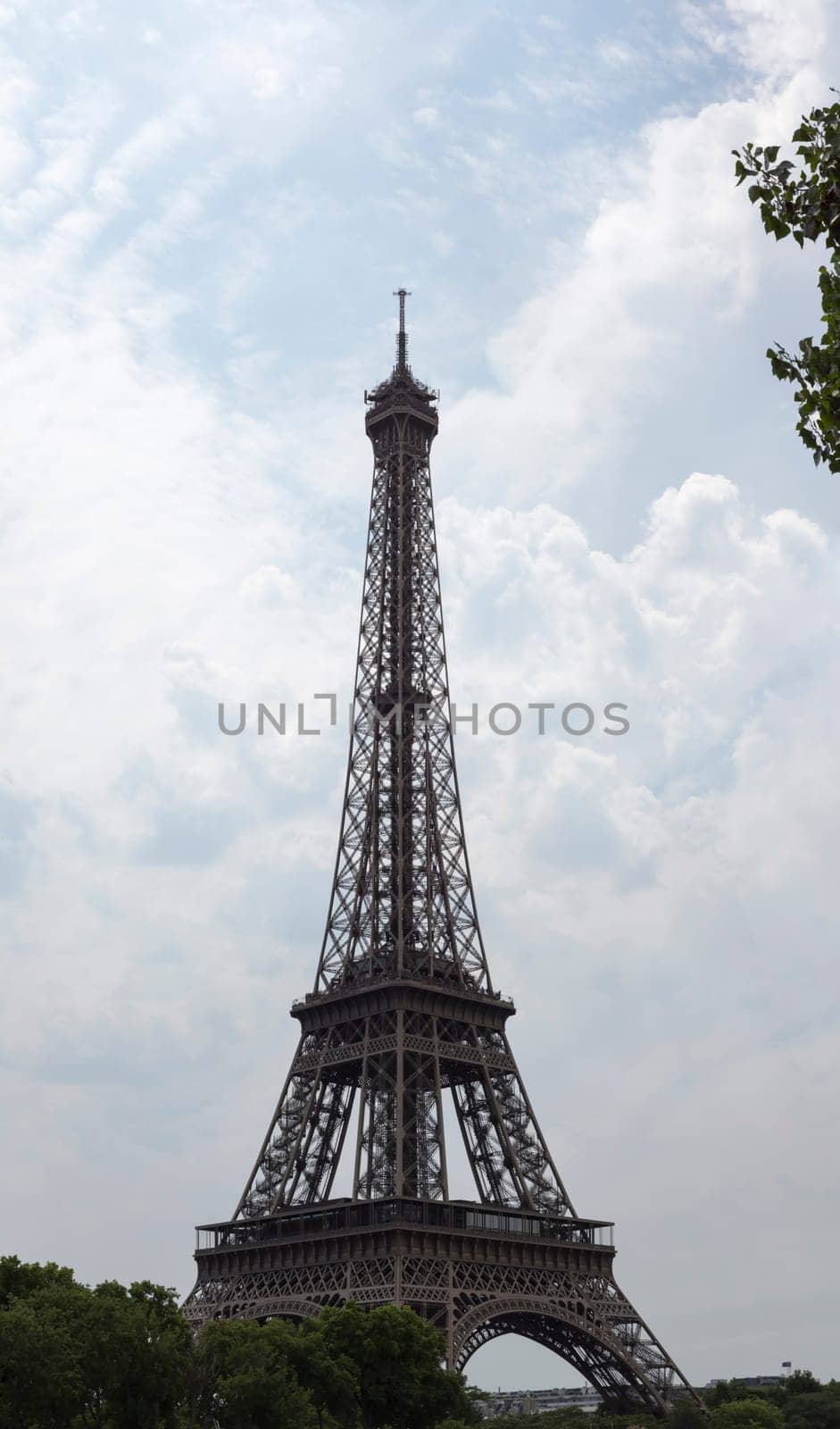 Eiffel Tower in Paris, France with clouds behind it.