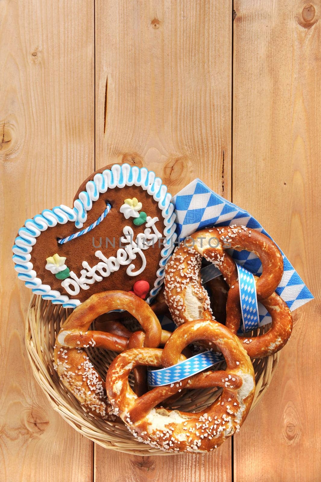 original Bavarian lye pretzels with gingerbread heart in a basket on wooden boards