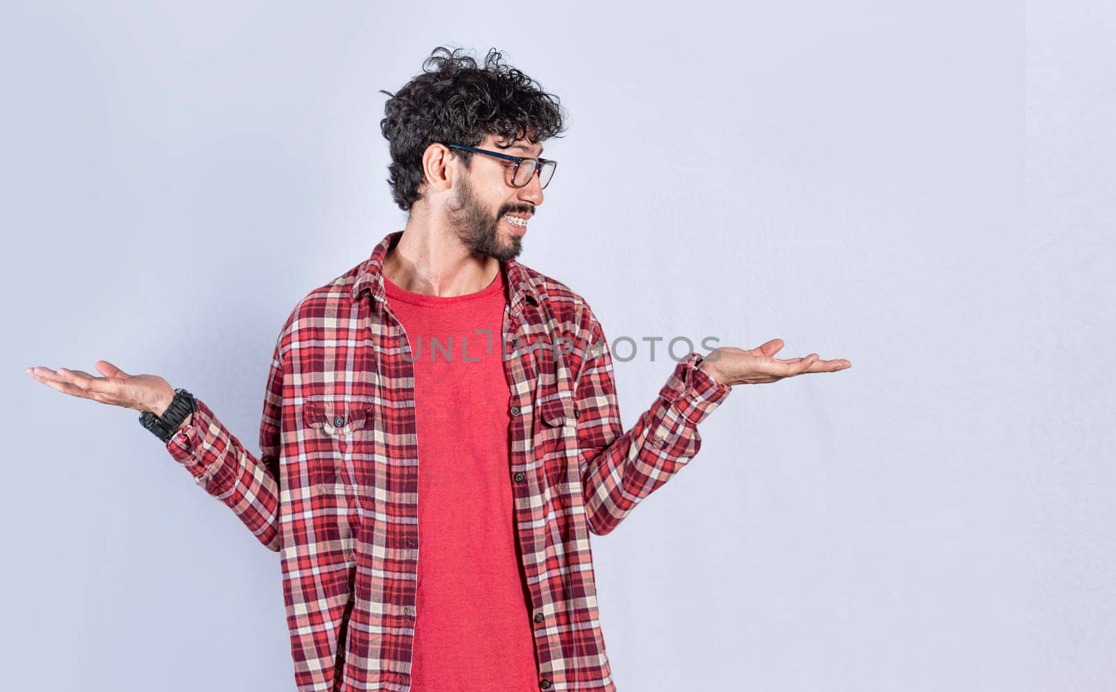 Handsome man balancing the palms of his hands ,Person comparing with the palms of his hands, a guy balancing the palms of his hands
