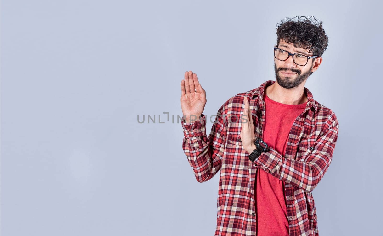Displeased intense man with rejection gesture, pulls palms in rejection, frowns in disgust. Displeased person rejecting with rejection gesture, throw palms isolated