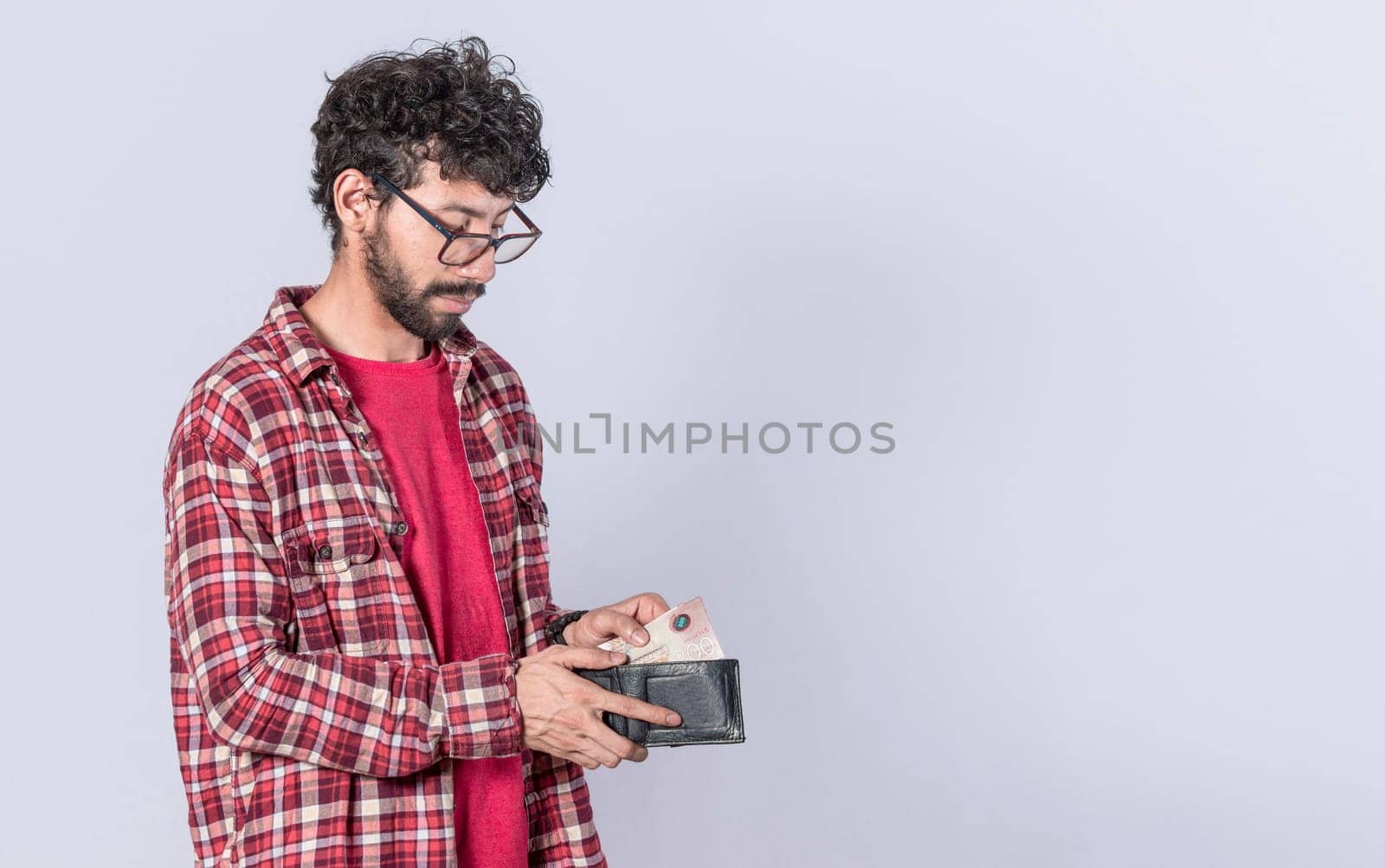 Portrait of man taking money out of his wallet, on isolated background, Person taking money out of his wallet on isolated background with copy space