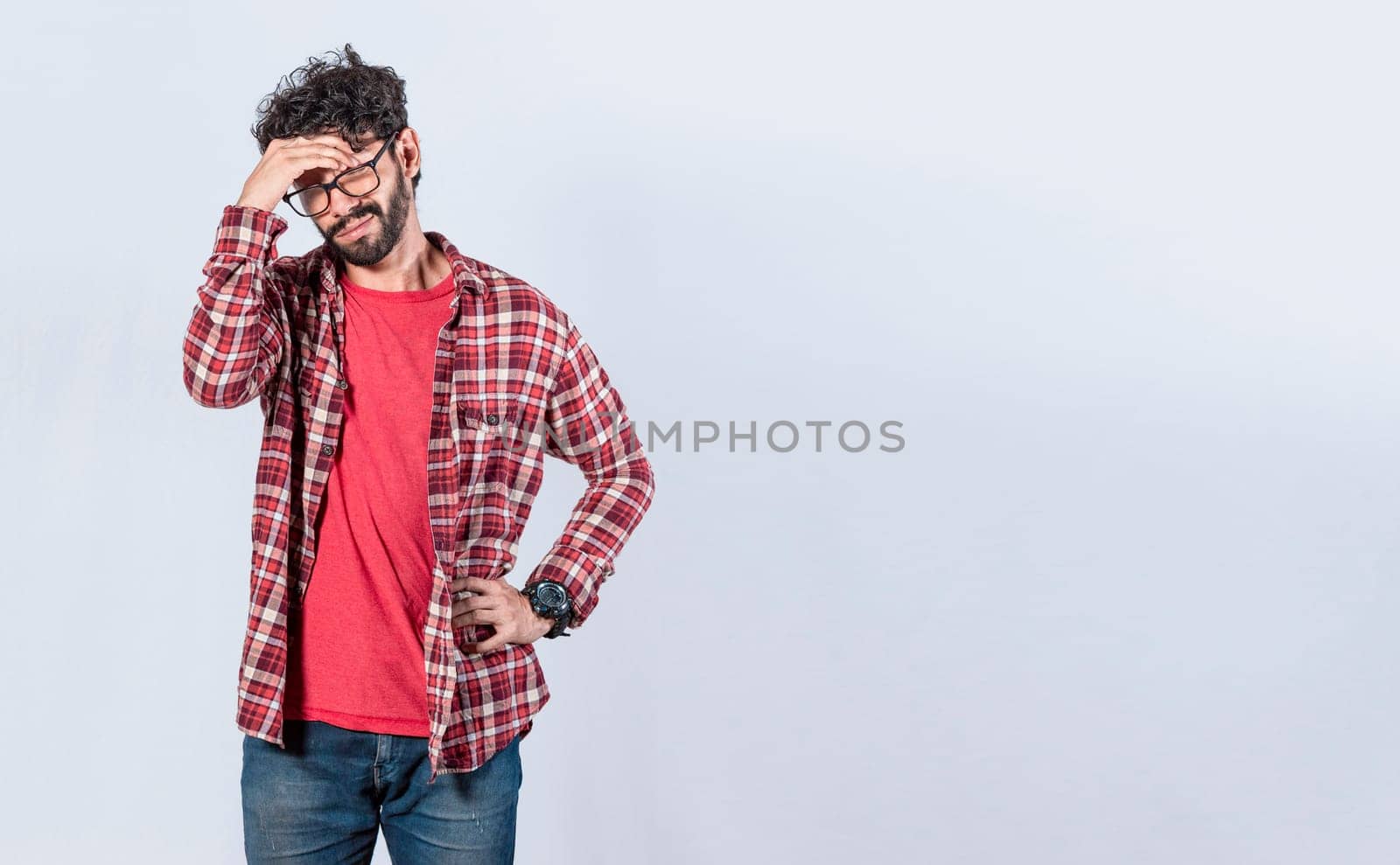 Worried man isolated, worried young man holding his forehead, tired man holding his head, man with headache