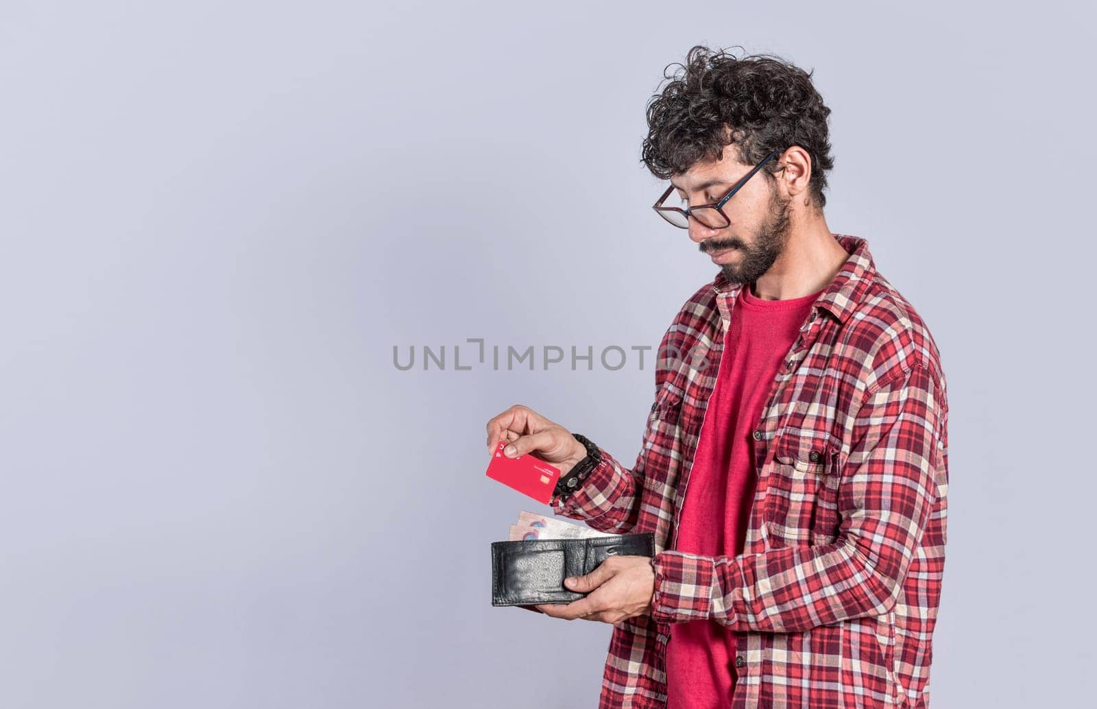 Person taking out credit card from his wallet, people taking out his debit card from his wallet on isolated background, concept of person paying with credit card with copy space