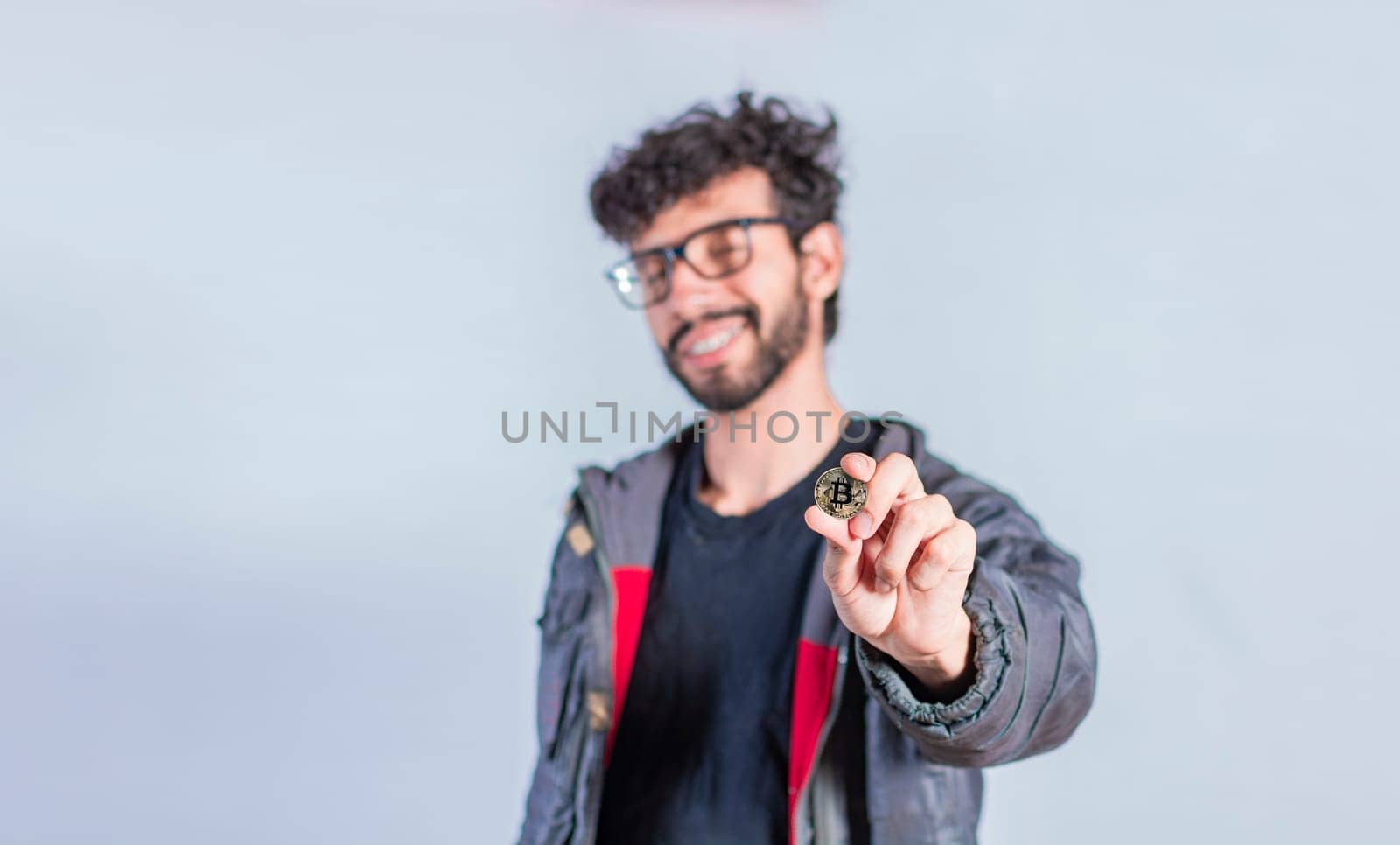 Smiling man holding bitcoin coin, Handsome man showing bitcoin coin, Person holding bitcoin coin isolated