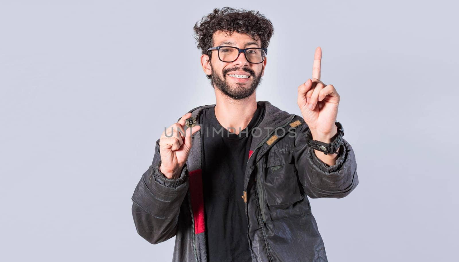 Smiling man holding bitcoin coin and lifting finger, Handsome man showing bitcoin coin, Person holding bitcoin coin isolated