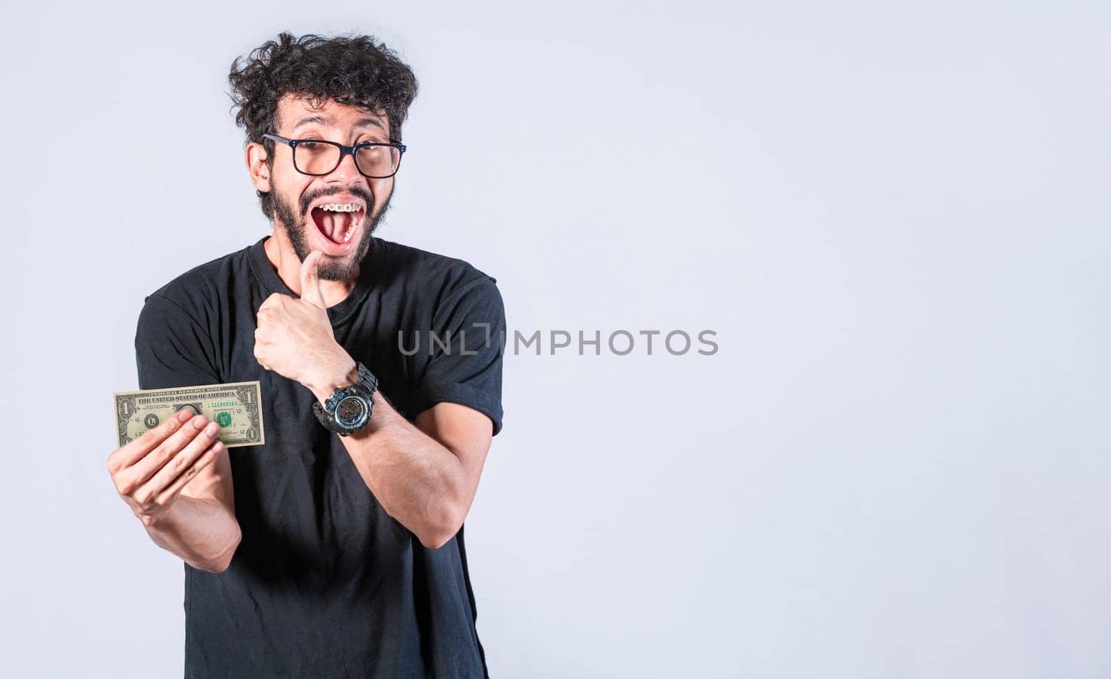 Happy man holding banknote in his hand, man with a banknote in his hand with thumb up, saving man concept, guy with money isolated