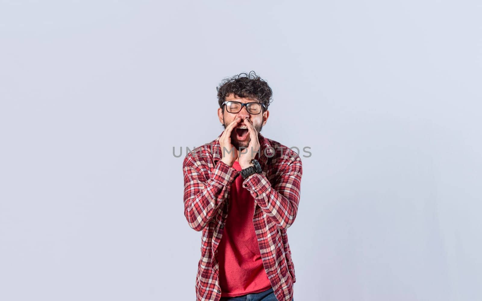 Handsome man in glasses shouting an announcement, isolated. A person announcing and yelling, concept of a guy yelling an announcement