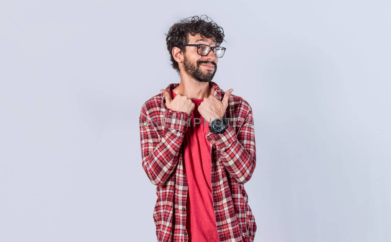 Handsome man pointing to the side, friendly guy pointing his fingers to the side, young man pointing at blank space