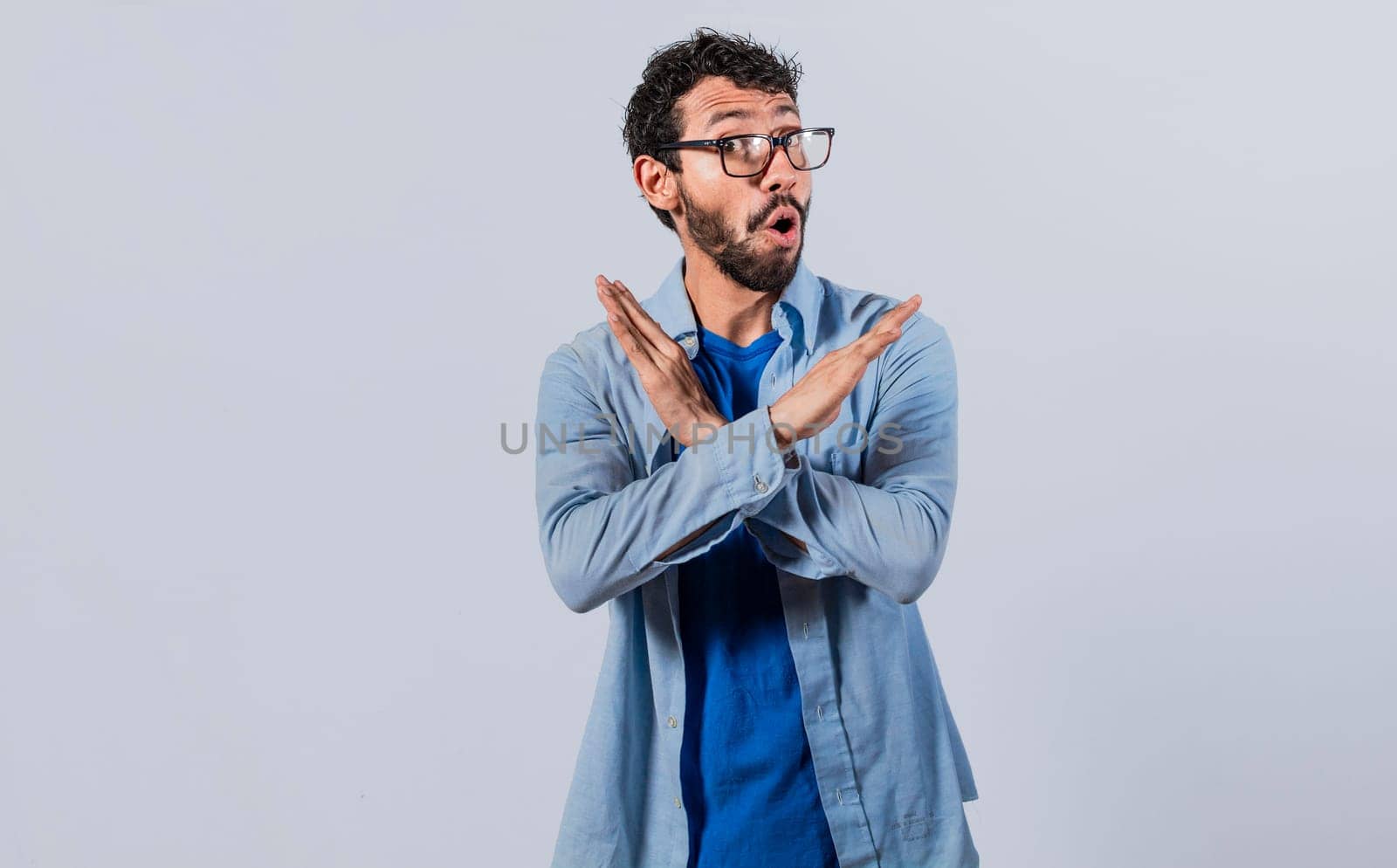 Man crossing arms in rejection, a man crossing his arms with rejection expression, concept of man rejecting