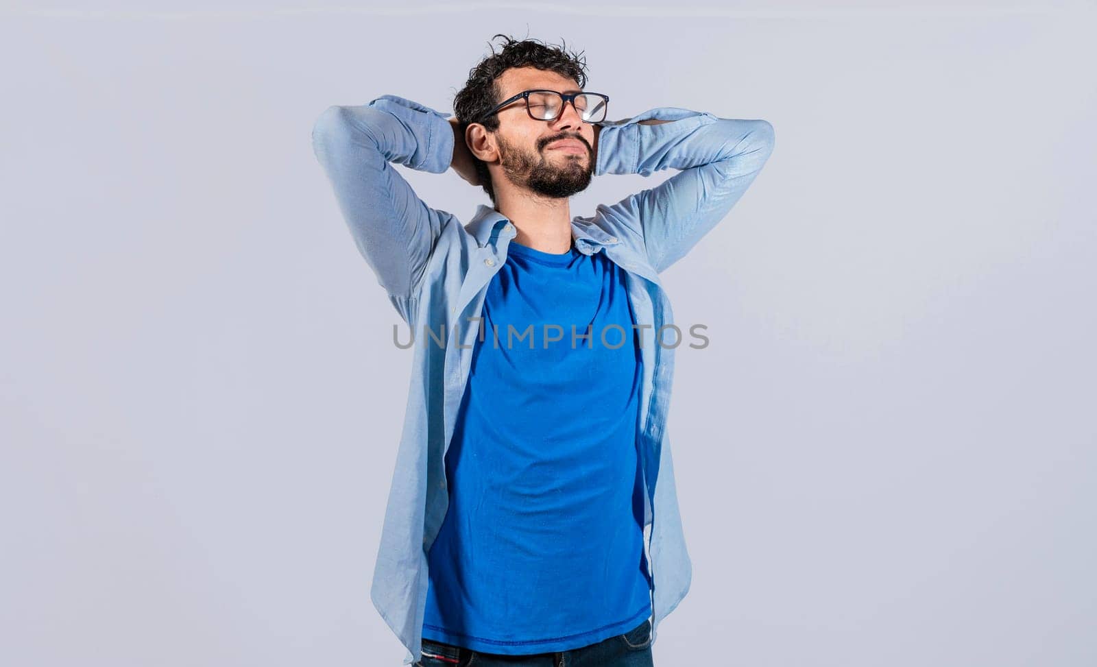 Relaxed smiling guy with hands behind his head, Relaxed man with closed eyes with hands behind his head, Satisfied man with hands behind his head, Concept of relaxed man with free time