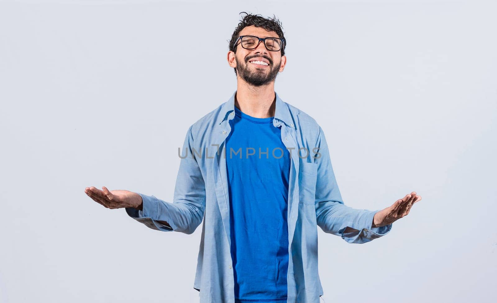 Generous man with open arms, Man sharing open hands looking at the camera with a friendly smile, Man welcoming head-on