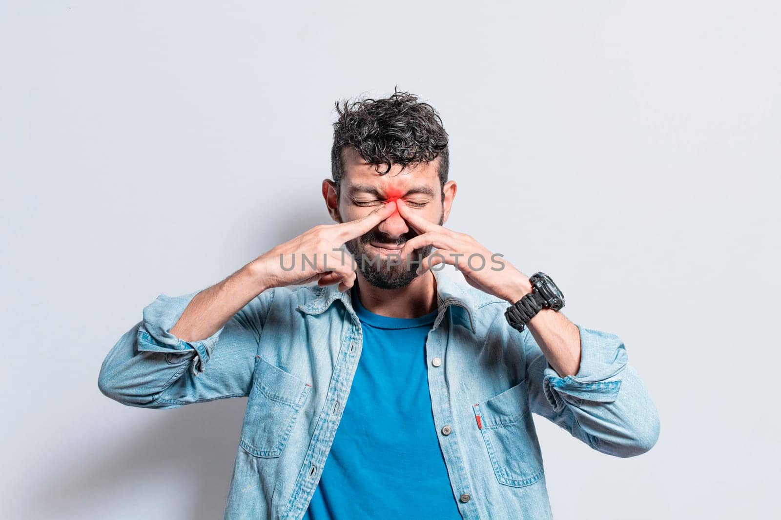 Man with nasal bridge headache, person with pain touching nose. sinus pain concept, A person with nasal bridge pain