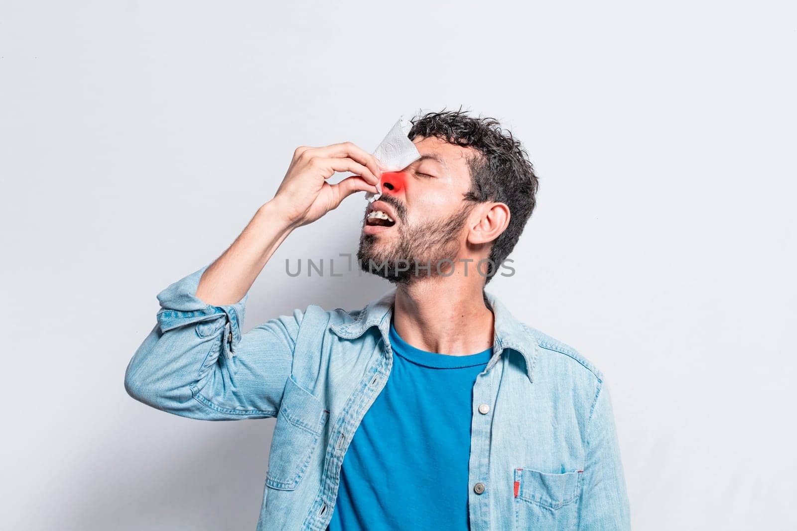 Person with irritated nose on isolated background, man with red nose cold, concept of person with sinusitis, Person with nasal congestion