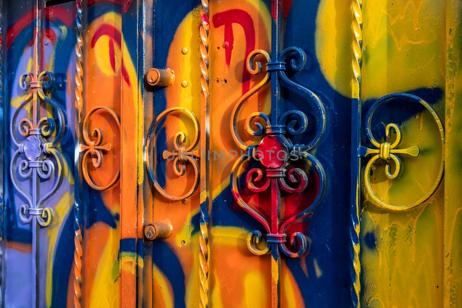 The door of the house smeared with the colors and paints of graffiti artists. Vibrant colors.