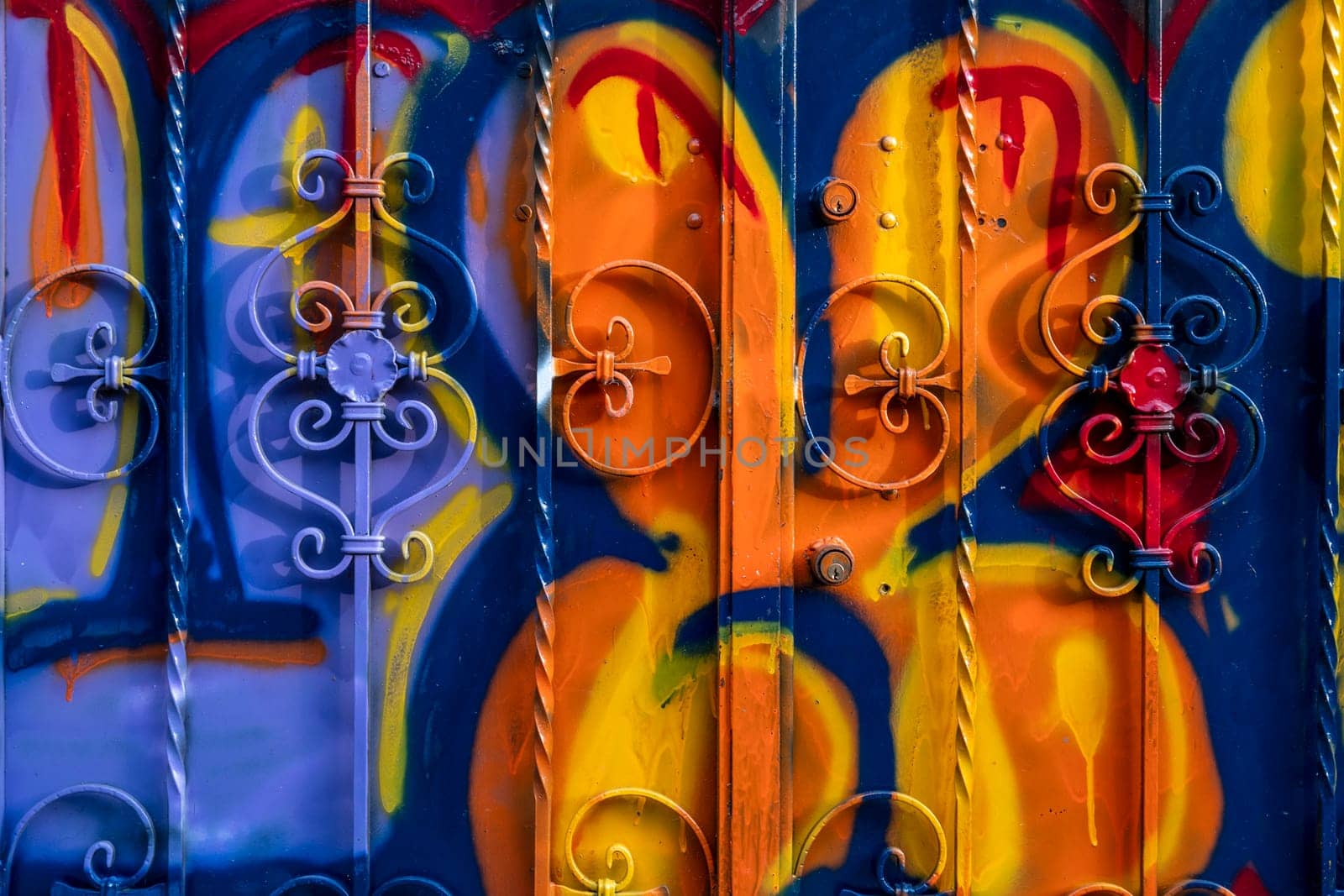The door of the house smeared with the colors and paints of graffiti artists. Vibrant colors.