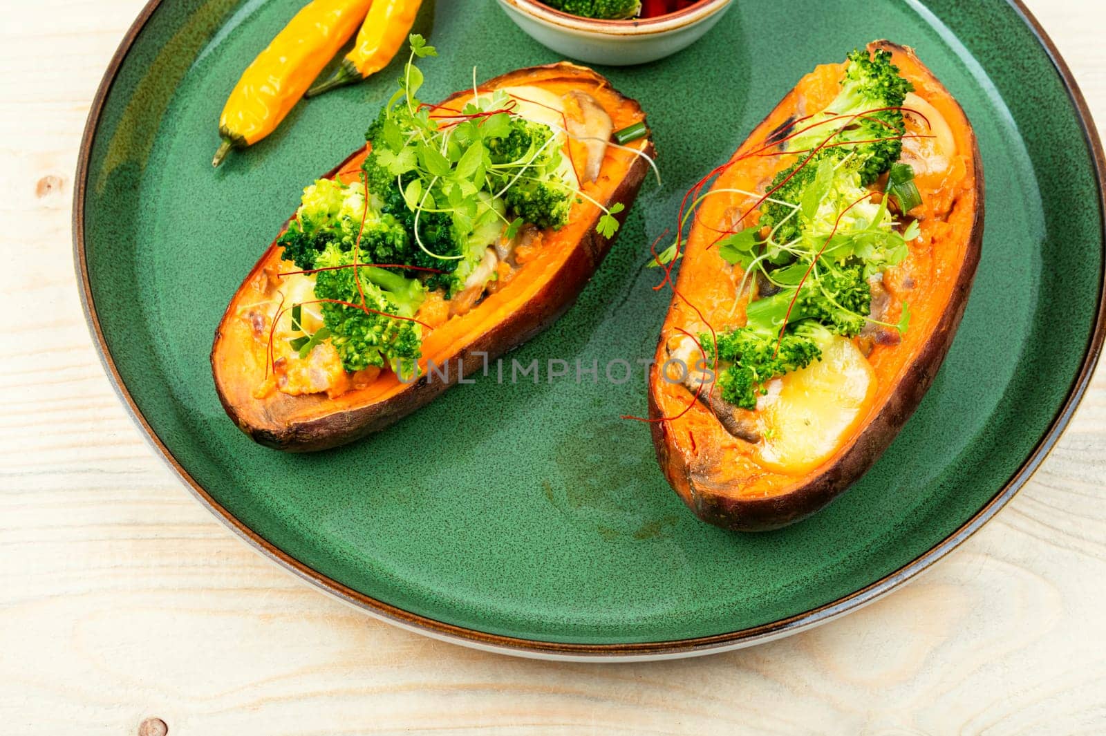 Baked sweet potato stuffed with mushrooms, broccoli and peppers. Healthy useful food