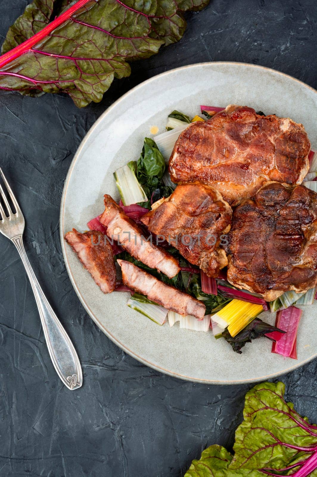 Delicious grilled meat steak and fresh herb salad