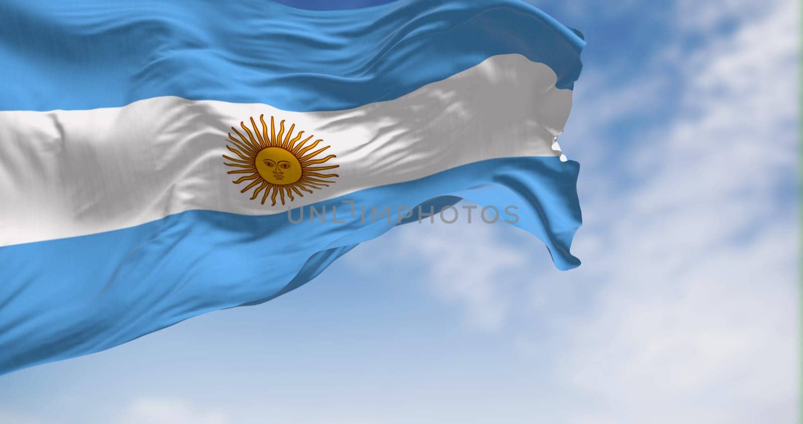Argentina national flag fluttering in the wind on a sunny day. Three equal blue and white horizontal bands with the Sun of May in the center. 3d illustration render. Selective focus