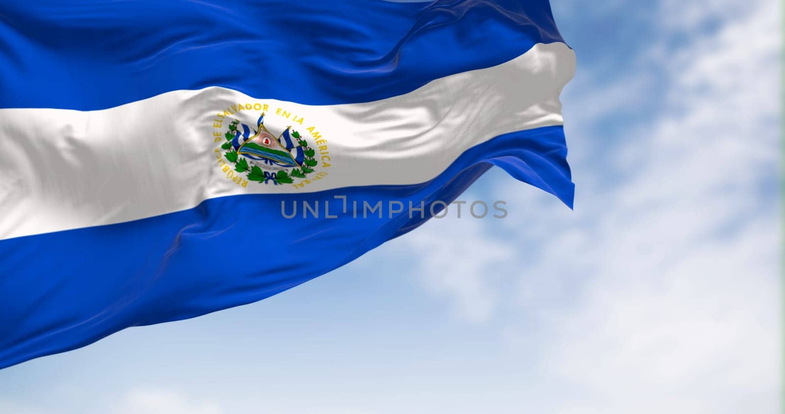 El Salvador national flag waving in the wind on a clear day. Three horizontal bands of blue and white with the national coat of arms in the center. 3d illustration render. Fluttering fabric