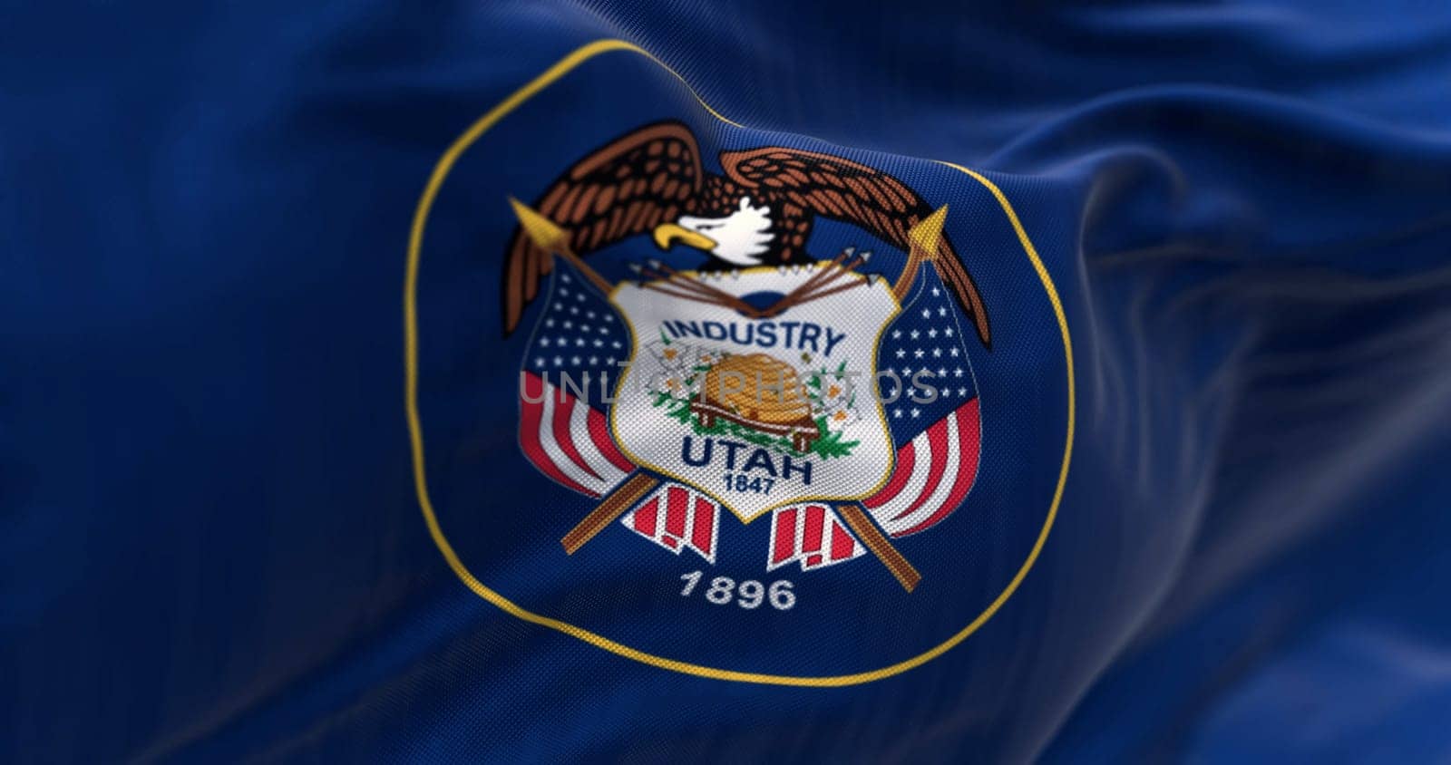 Utah state flag fluttering in the wind. State seal surrounded by a golden circle on a dark blue background. 3D illustration render. Close-up. Fluttering fabric background