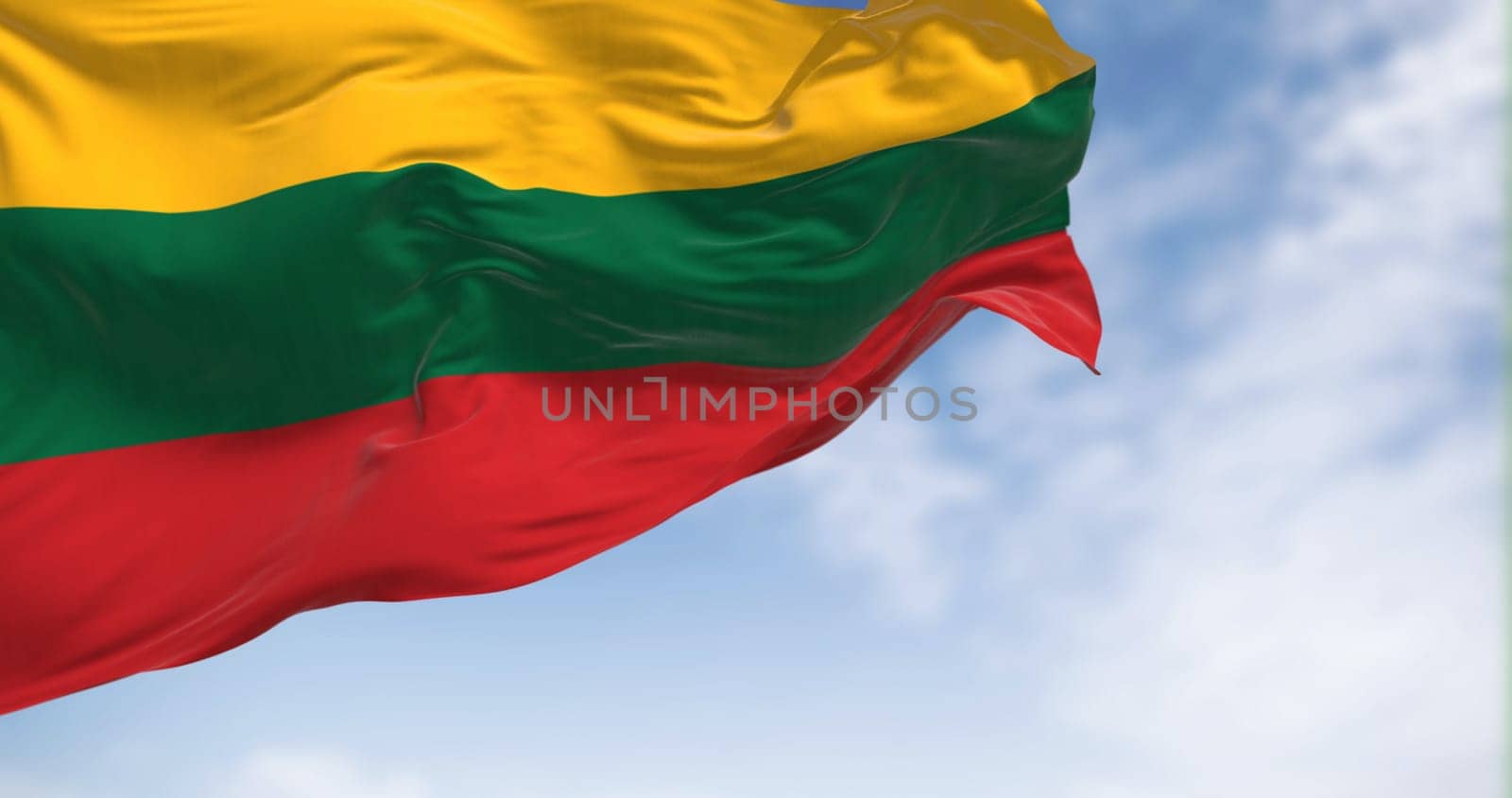 National flag of Lithuania waving in the wind on a clear day. Horizontal tricolor of yellow, green, and red stripes. 3D illustration render. Fluttering textile