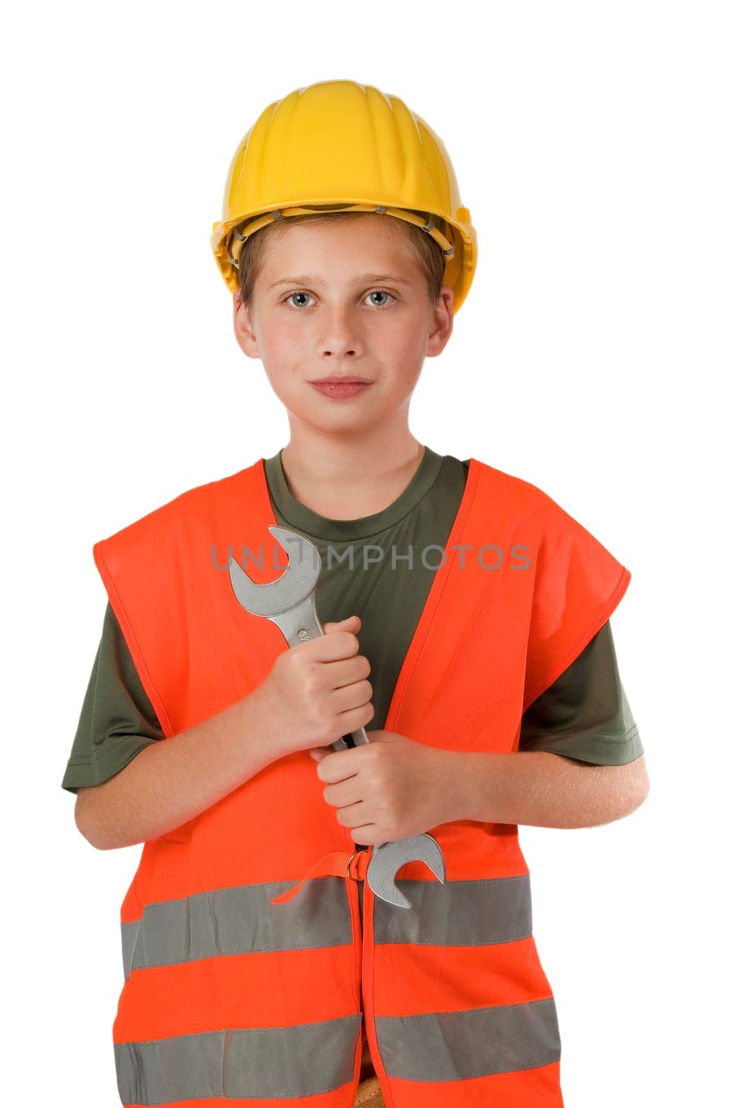 Front upper body view of a 10 year old boy wearing an orange safety vest and holding a large open-end wrench in front of him isolated on white.