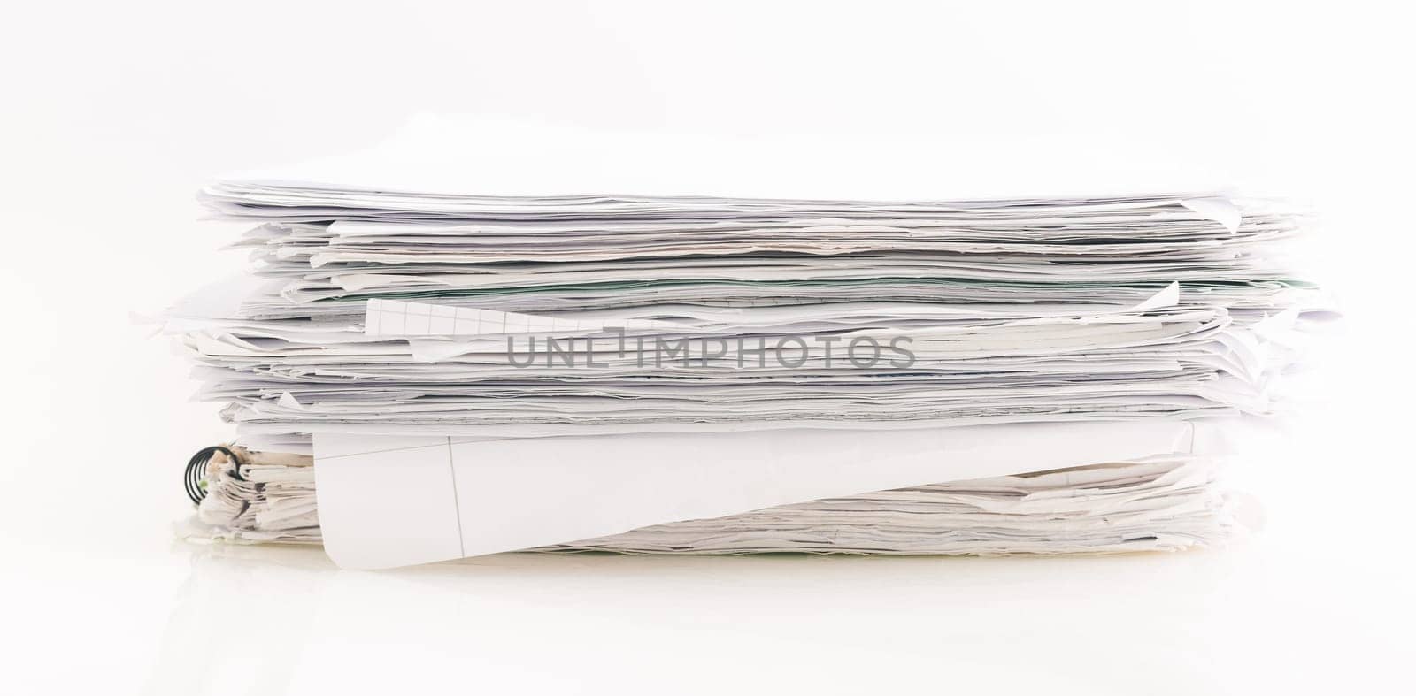 Large pile of waste paper isolated on white, ready for recycling.