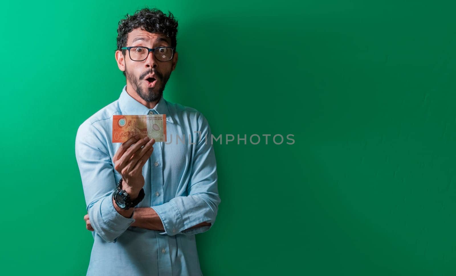 Amazed man holding single money bill and looking at camera, Surprised person showing single money bill to camera, Amazed people holding a money bill. Man holding a nicaragua money bill