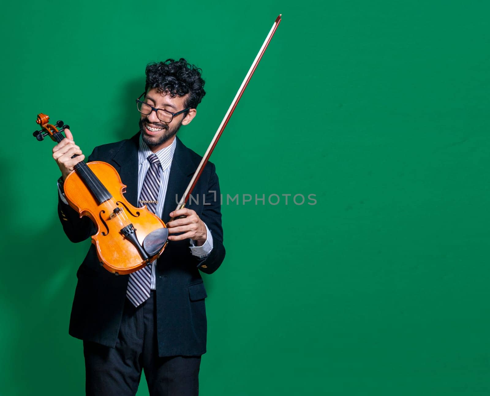 Smiling violinist man looking at camera and holding his violin, Violinist man concept on isolated background, Portrait of a smiling violinist man isolated