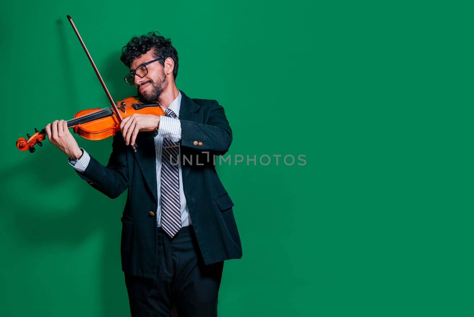 Portrait of music teacher playing his violin isolated, Person in suit playing violin on isolated background, Handsome man in formal suit playing violin isolated