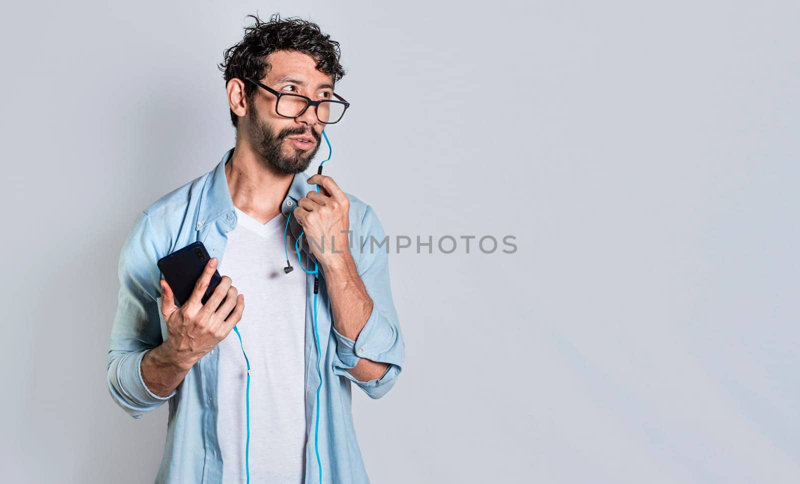 handsome man using handsfree while calling on cellphone, Person using handsfree on a cellphone call isolated, people on a call using handsfree