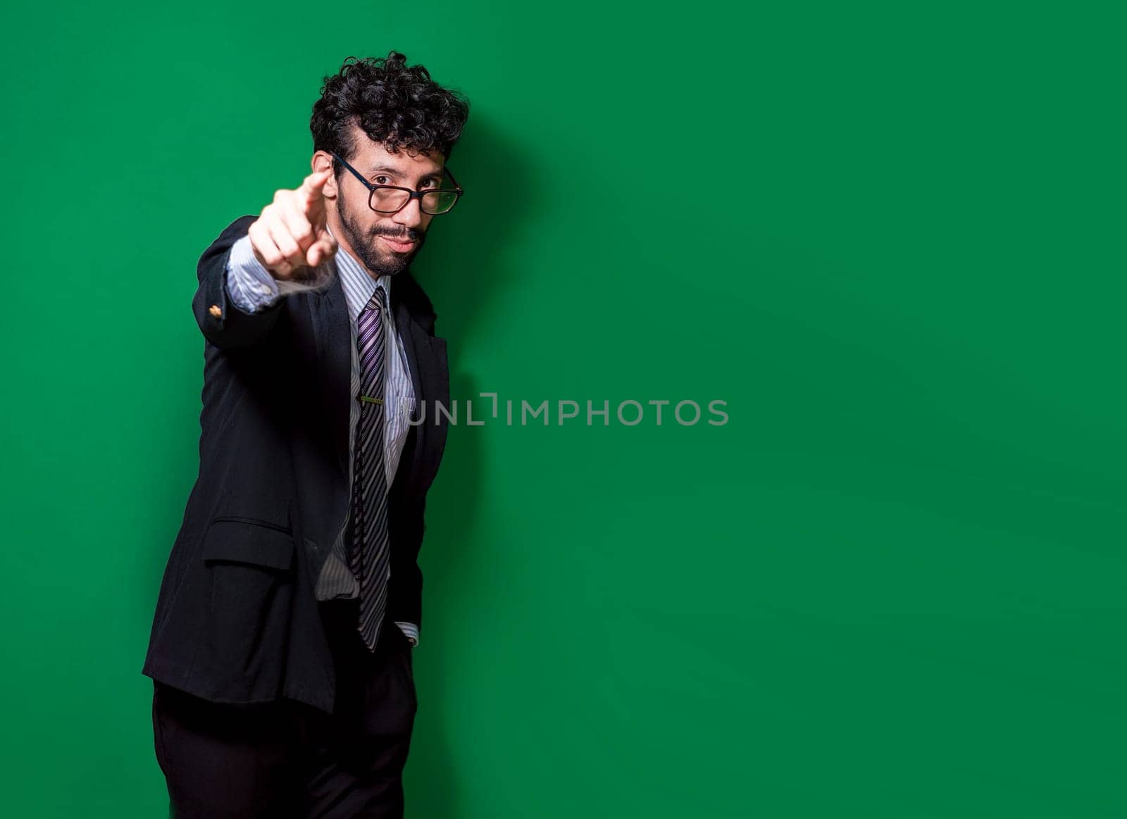 Friendly smiling business man pointing at you, Positive business people pointing at camera. Young businessman with positive attitude pointing at me