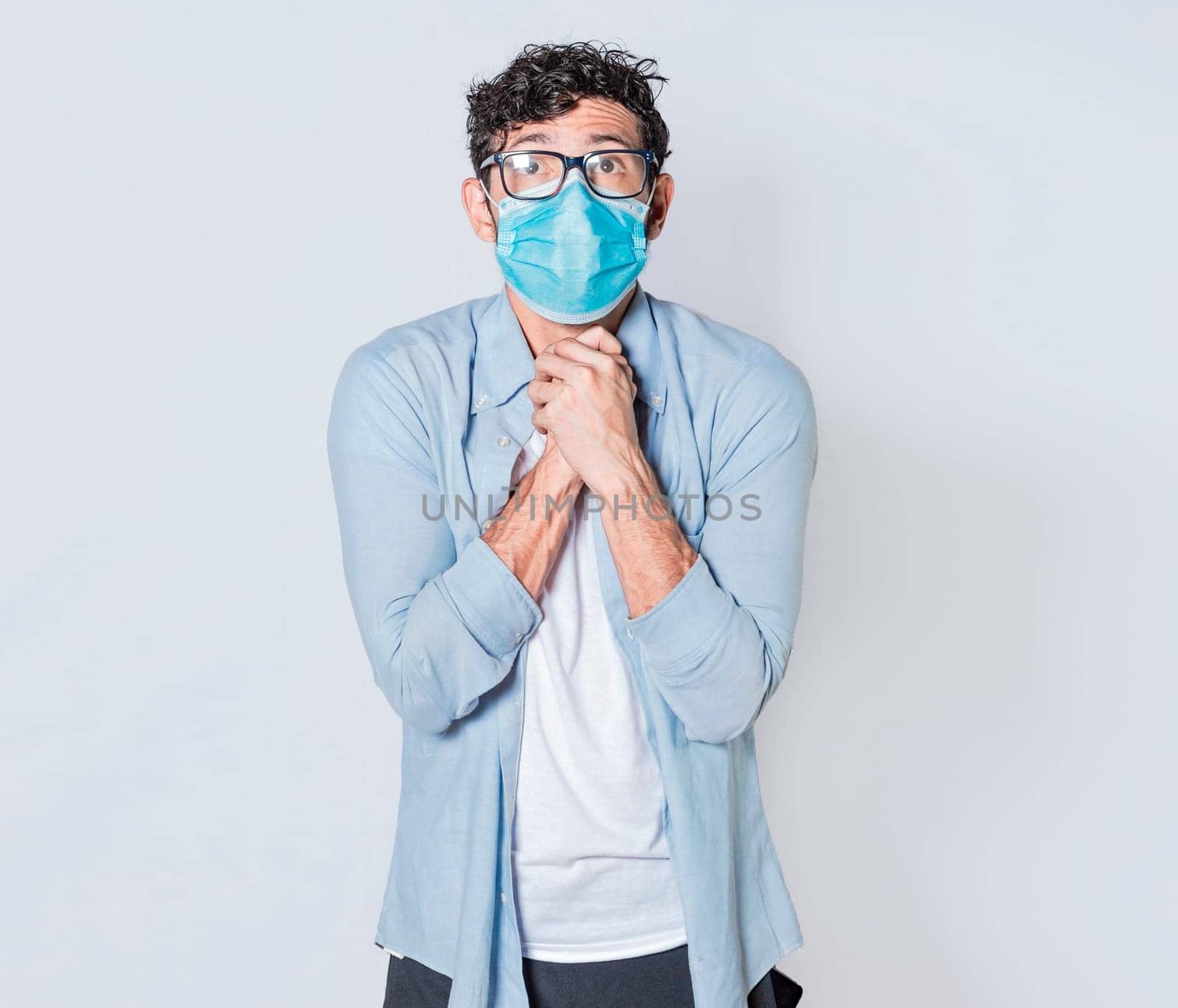 Latin man begging with medical protective face mask. pleading man concept isolated, man asking for a favor