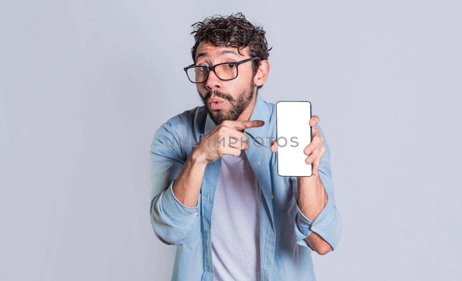 Amazed man showing mobile screen, Shocked person showing and pointing at his smartphone screen, Amazed people showing and pointing at blank cell phone screen