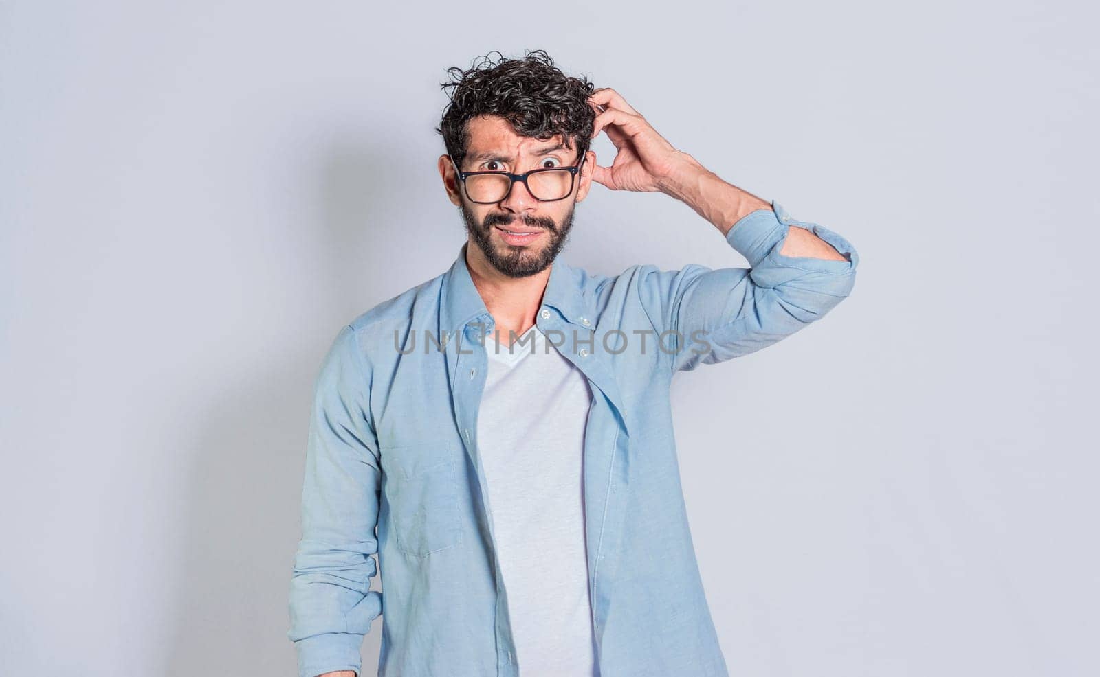 Confused person scratching his head on isolated background, Handsome man scratching his head with confused face isolated