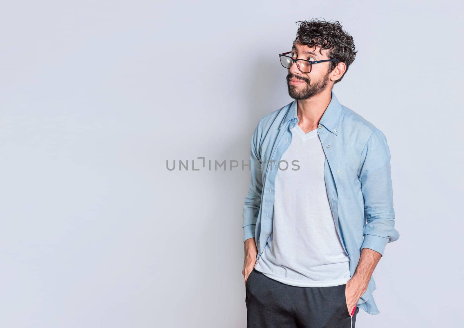 Smiling person thinking seeing a blank space, handsome man thinking looking to the side, smiling man thinking and seeing a blank space