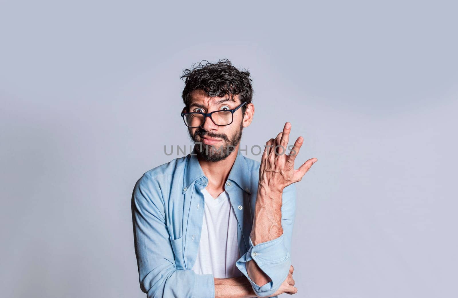 Puzzled man gesturing with one hand, Person with puzzled face frowning, Close up of puzzled people gesturing with hands.