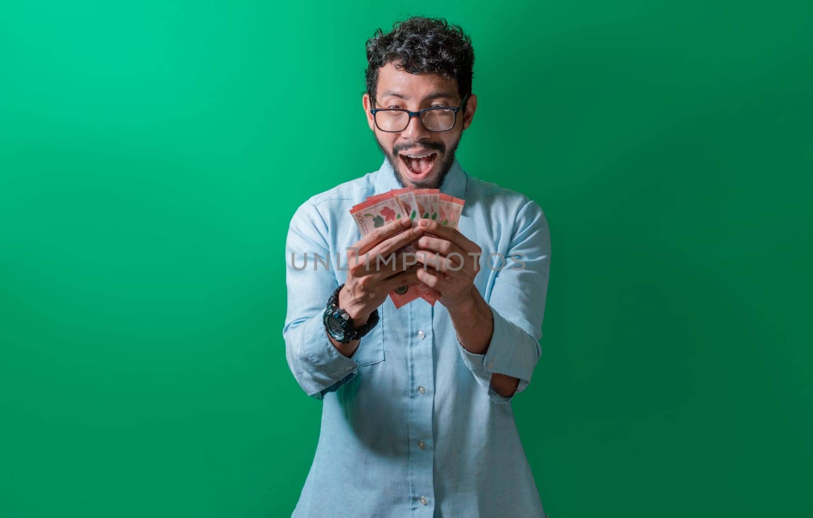 Happy person looking at the money in his hands, Amazed man with banknotes in his hand, Excited person looking at the money in his hands isolated.