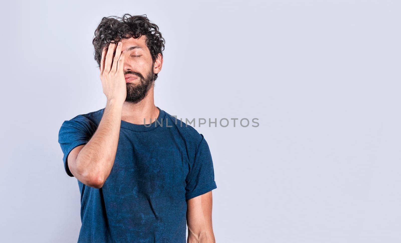 Exhausted person putting the palm of his hand on his face. Tired and exhausted man covering his face with the palm of his hand, Concept of a bored and tired man