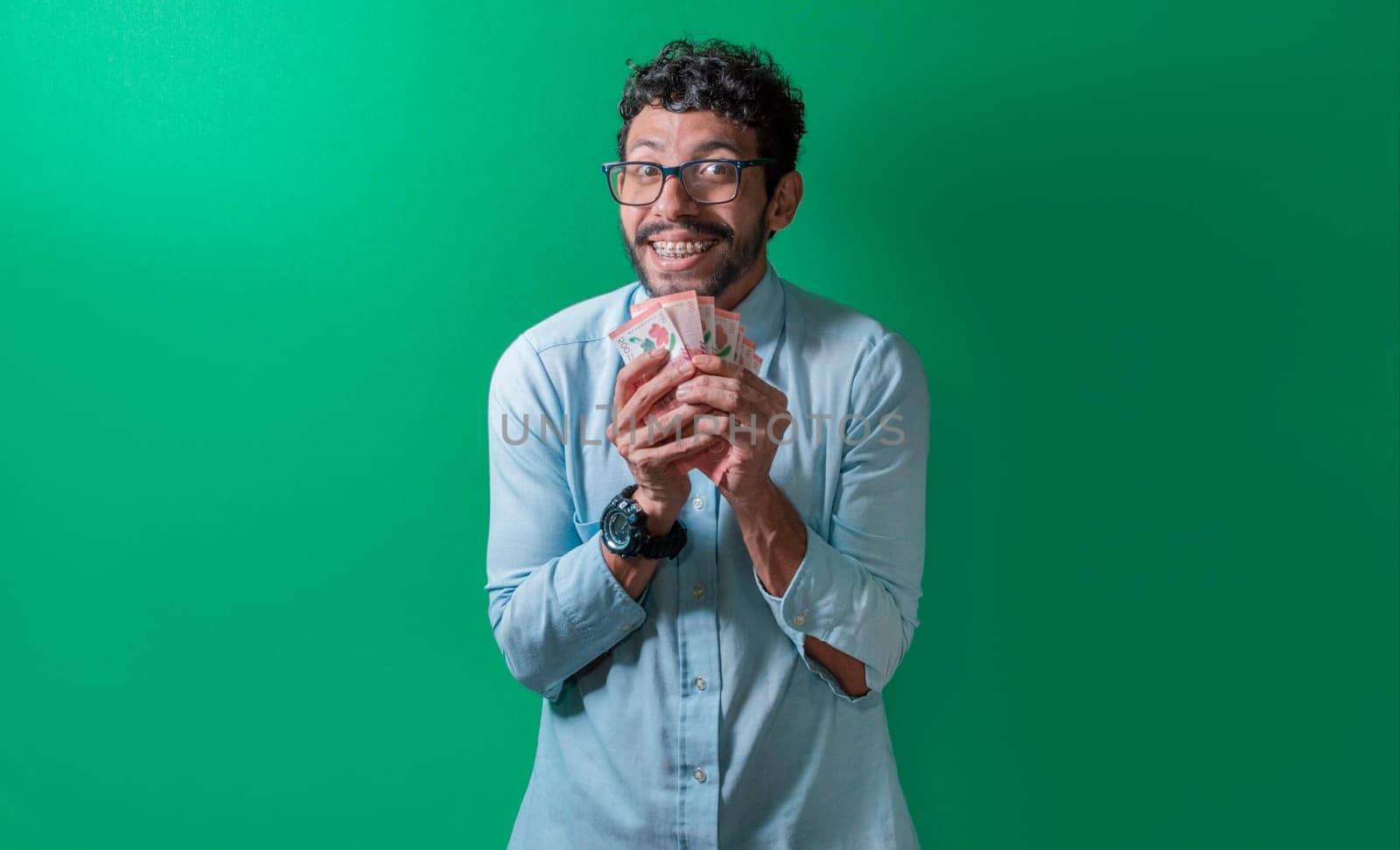 Friendly and happy man with money in his hands looking at the camera, Happy person with money in his hands isolated. Happy person with money in his hands looking at the camera