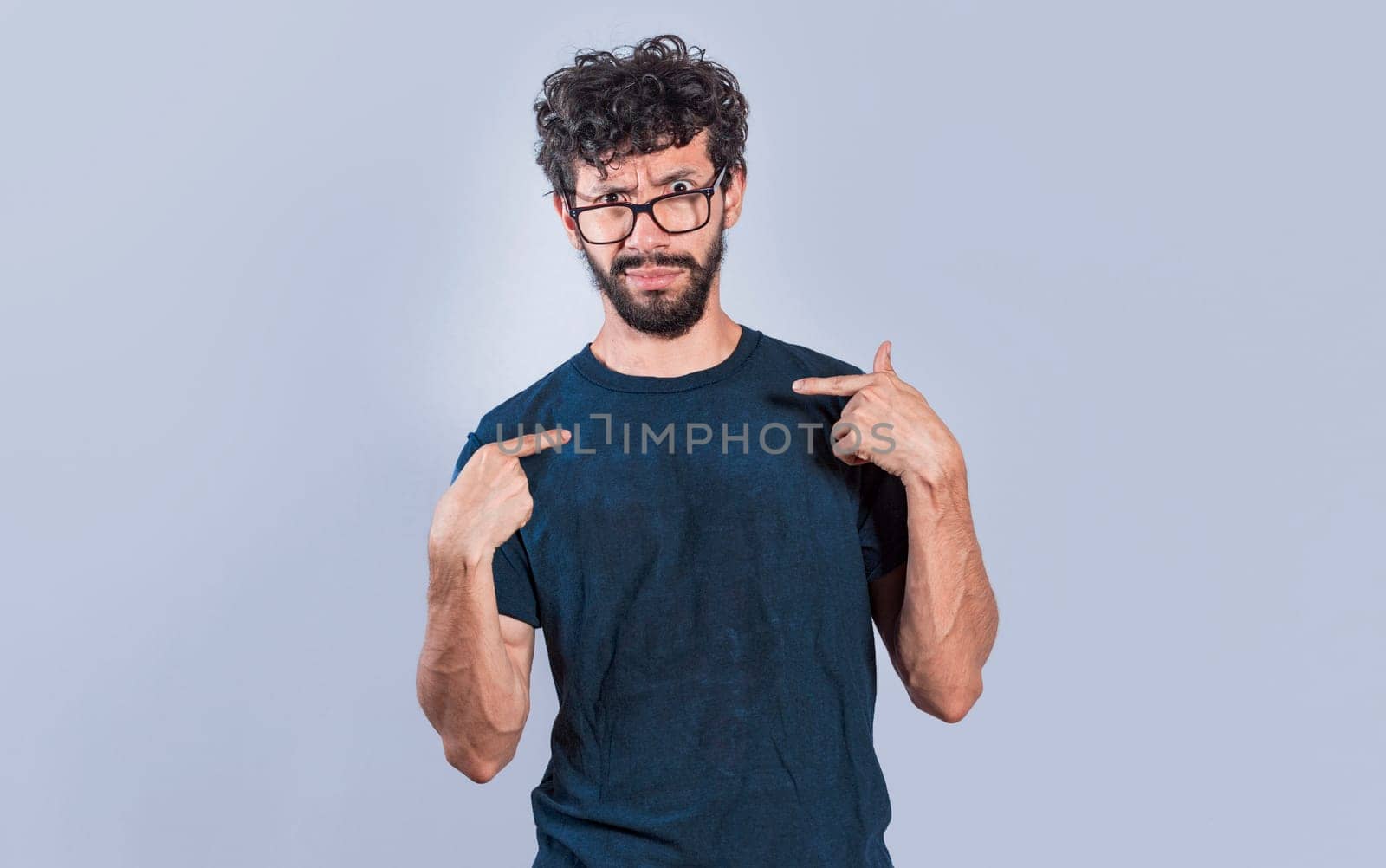 Man with puzzled face pointing at himself, person with confused gesture pointing at himself. bewildered people pointing to self, person with you are talking to me expression.