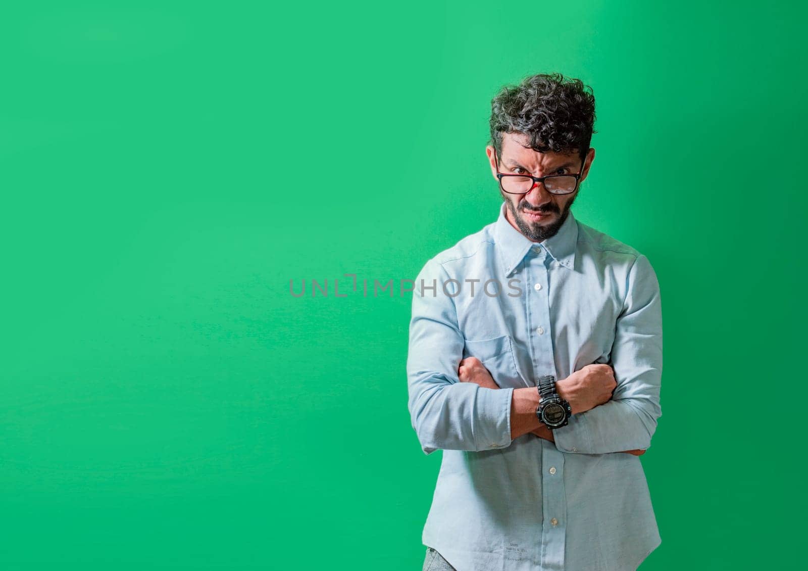 Angry and annoyed man with crossed arms isolated, Unhappy and angry person with crossed arms, Serious and angry man with crossed arms looking at camera