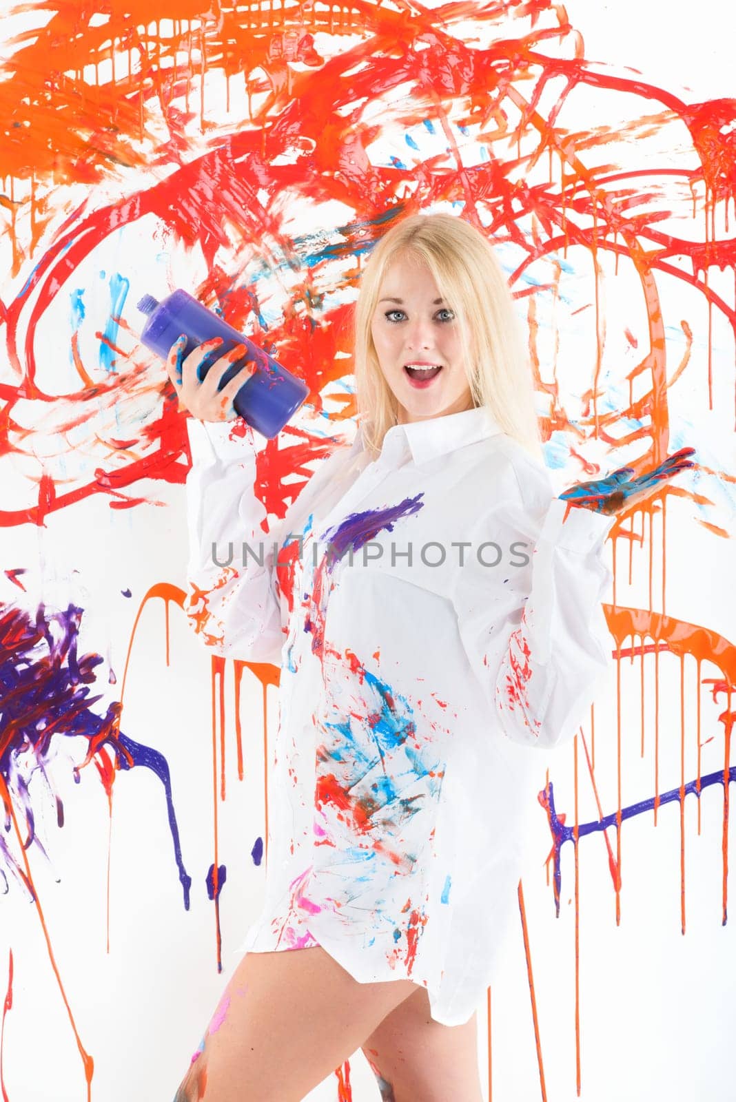 Colorfully painted woman presents finger painting colors