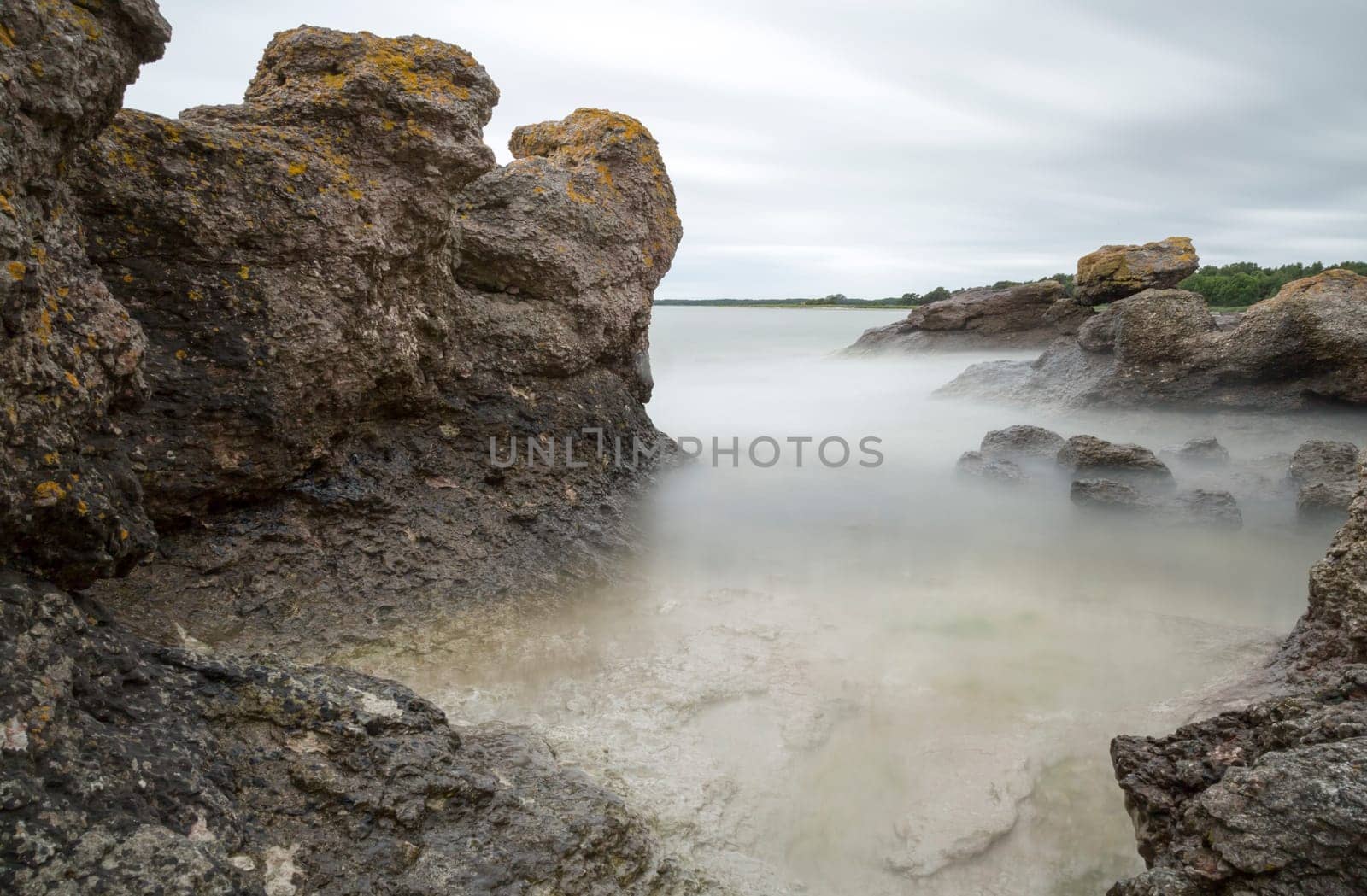 Sea Stack by Ocean in Gotland, Sweden with clouds in the sky.