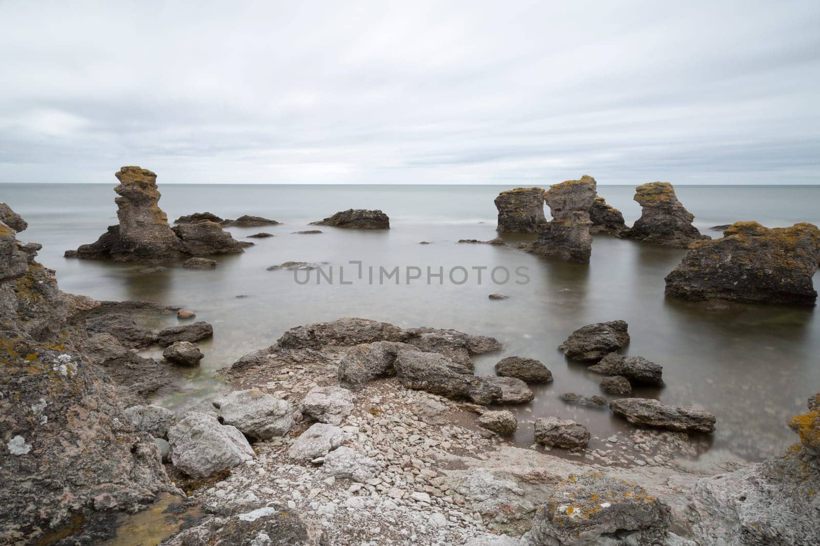 Sea Stack by Ocean in Gotland, Sweden with clouds in the sky.