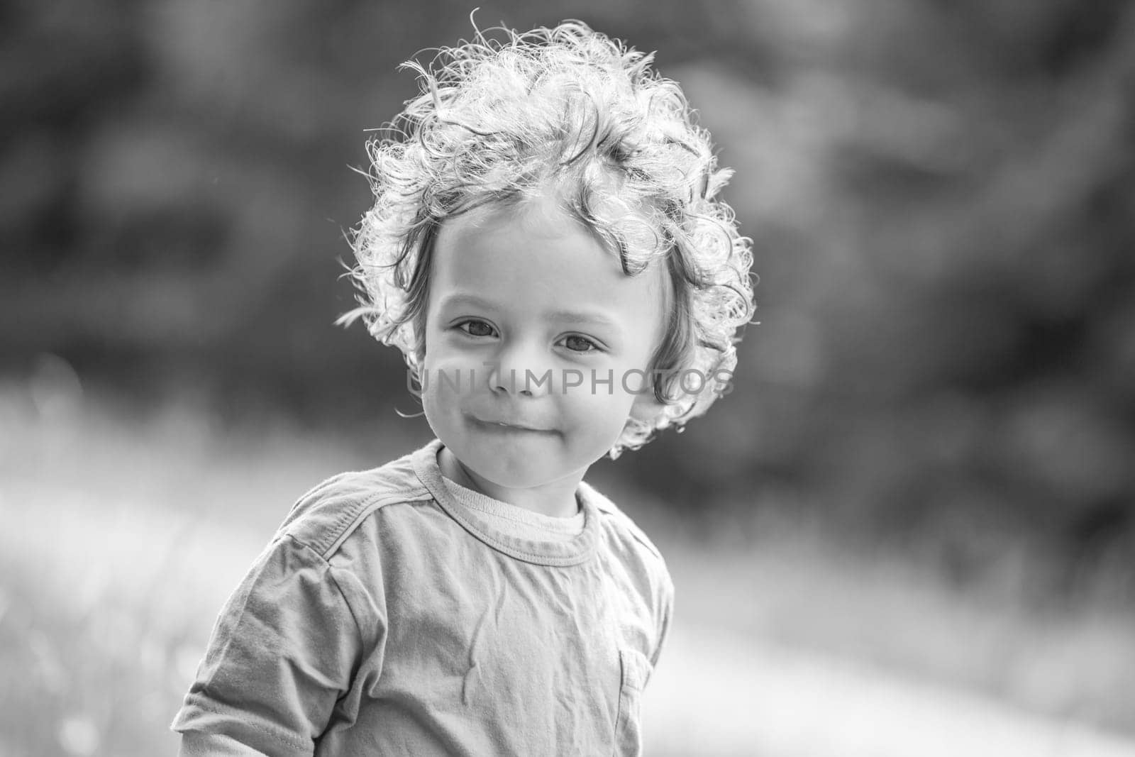 Portrait of 1 year old baby boy having fun on a mountain meadow.