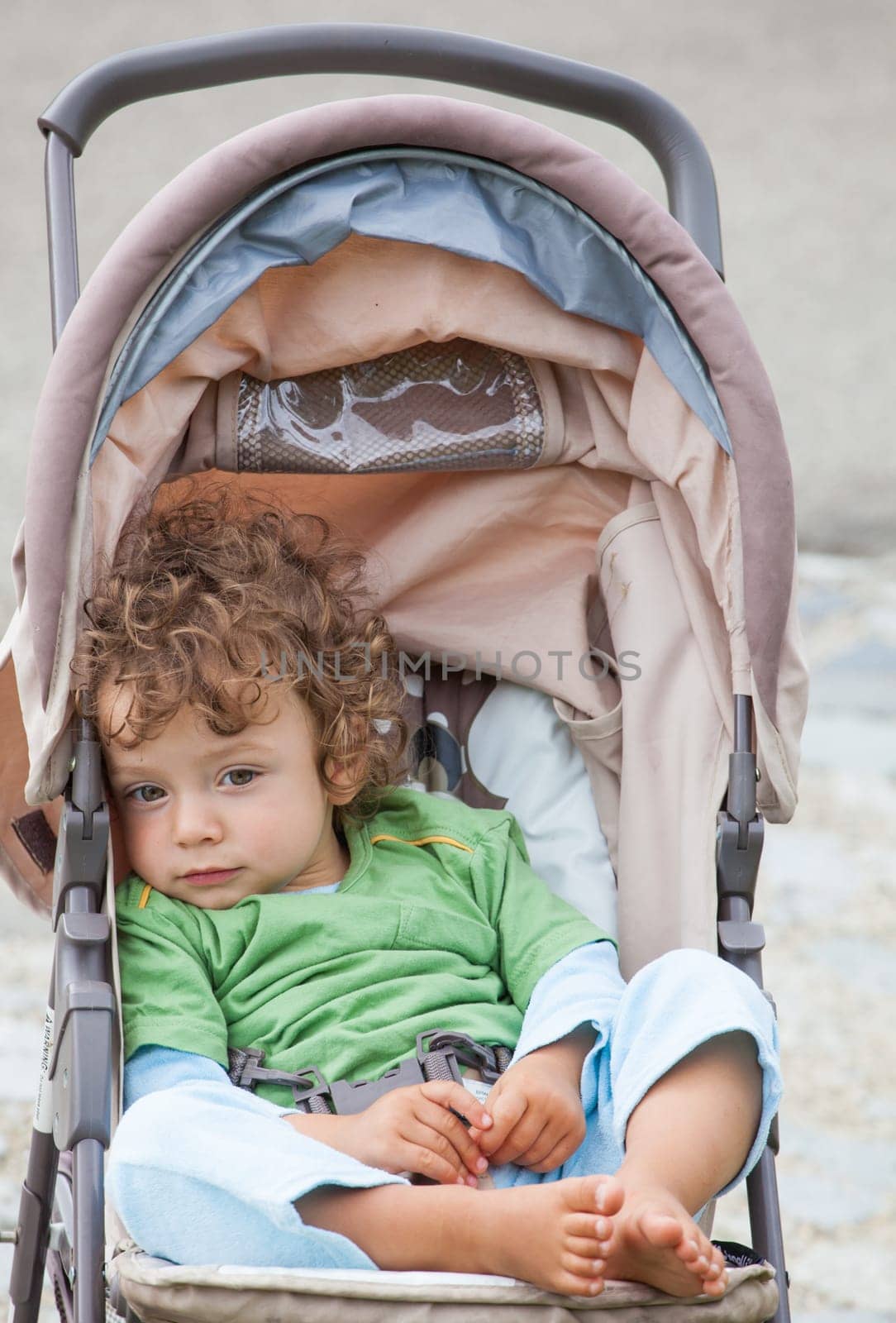 Portrait of 1 year old baby boy in a stroller.