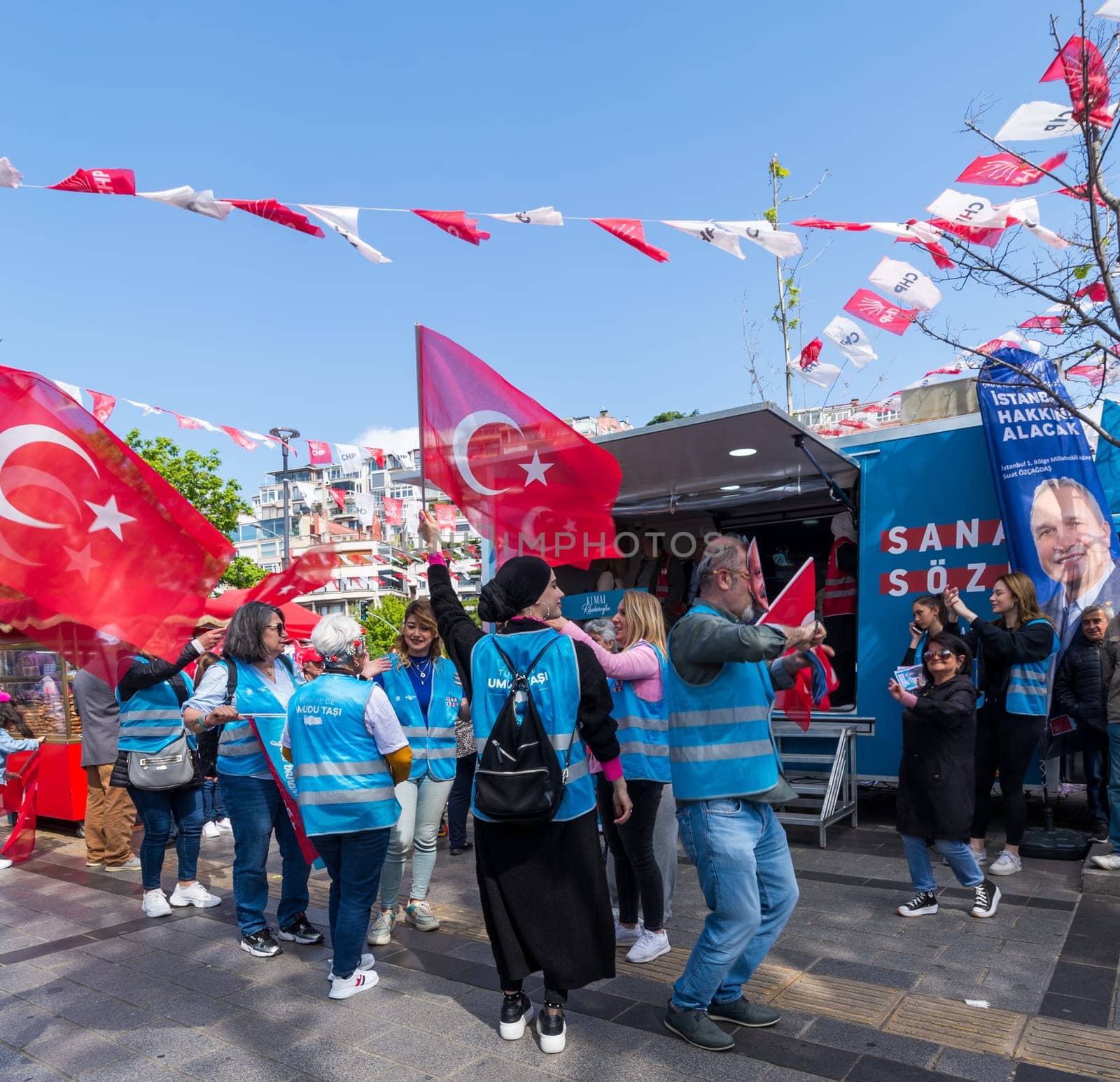 Istanbul, Turkey - May 13 2023: Supporters of Kemal Kilicdaroglu dancing while holding the Turkish flags in front of Republican Peoples Party kiosk in Uskudar neighbourhood during 2023 elections