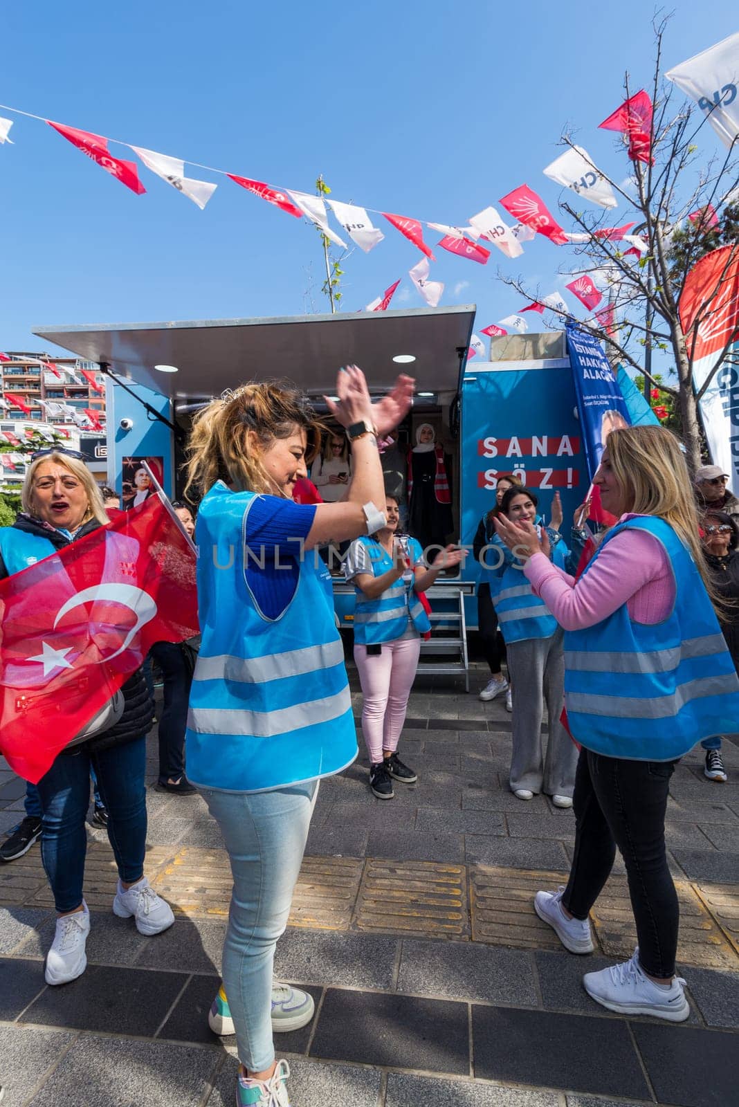 Istanbul, Turkey - May 13 2023: Supporters of Kemal Kilicdaroglu dancing while holding the Turkish flags in front of Republican Peoples Party kiosk in Uskudar neighbourhood during 2023 elections