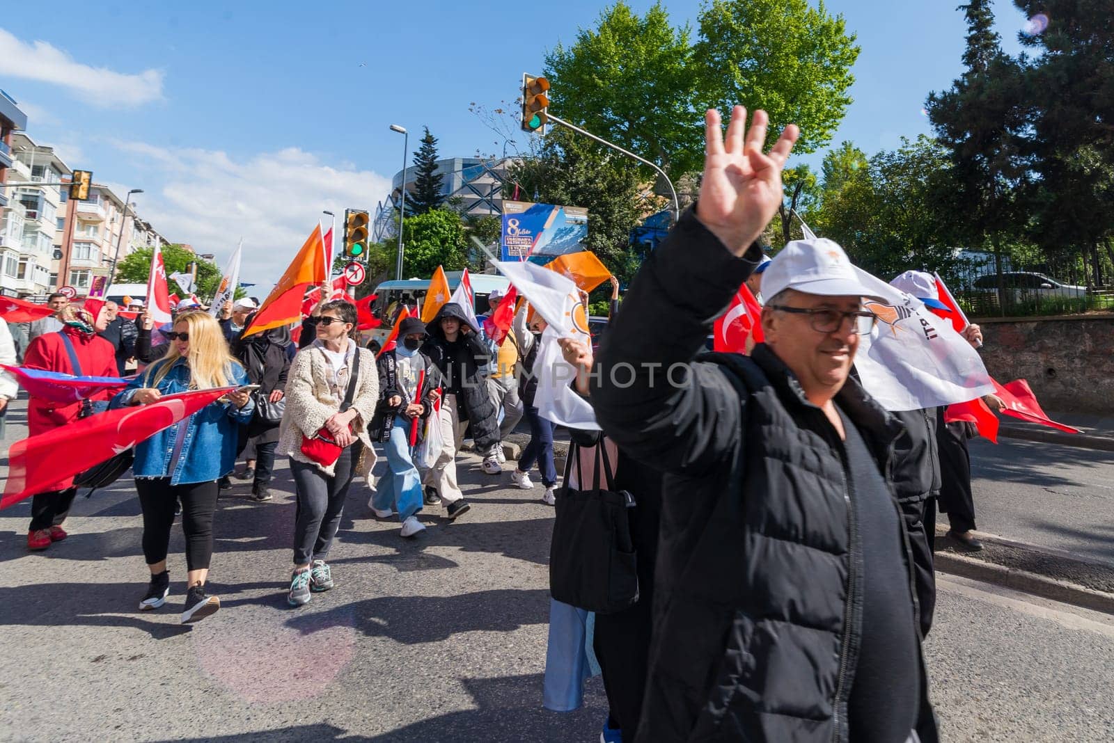 Istanbul, Turkey - May 13 2023: Man making four fingered sign during march of AK Party in Cumhuriyet street, Uskudar neighbourhood during 2023 elections